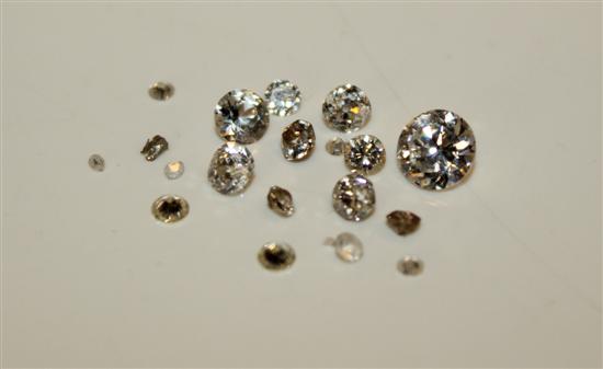 Small bag of loose diamonds and a larger simulated diamond.